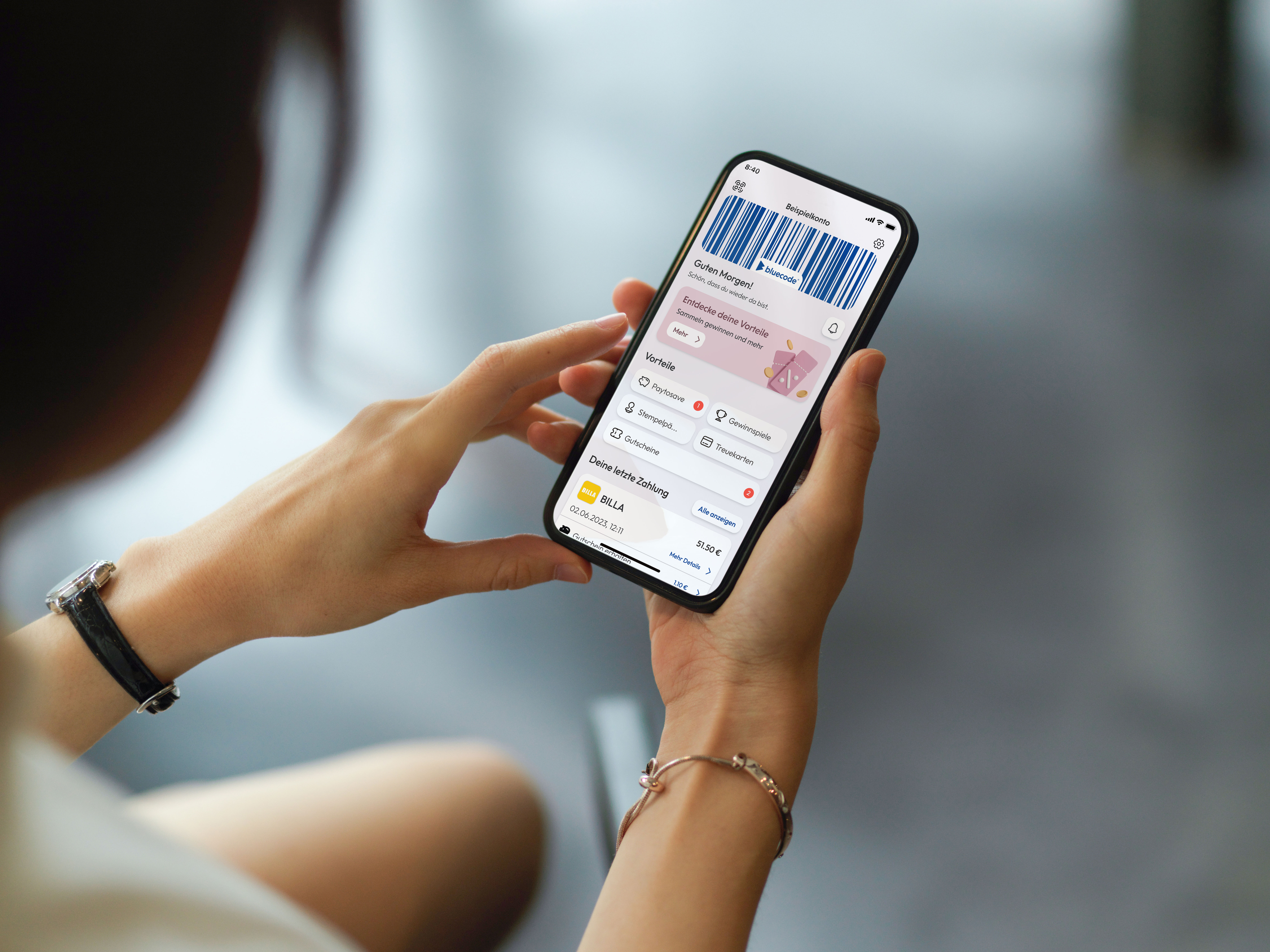Bluecode Zahlmethode auf einem Smartphone in den Händen einer Frau.